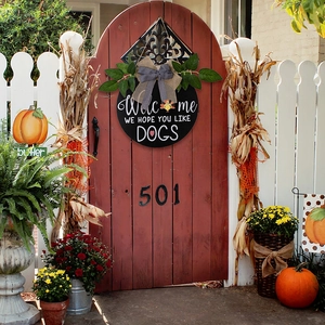 Close-up of rustic fall welcome sign with turkey icon and decorative burlap bow on a red door