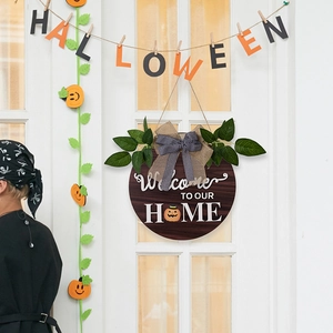 Detail of Halloween welcome door sign with pumpkin icon and black white check bow