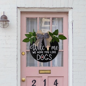 Rustic round Welcome door sign with green leaves and Hope You Like Dogs text decor