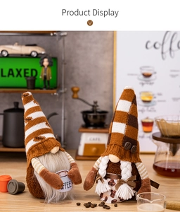 Detail of knitted coffee gnomes figurines with coffee bean apron and coffee cup prop