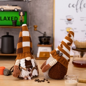 Close-up of coffee gnome plush dolls featuring knitted hats and rustic burlap details