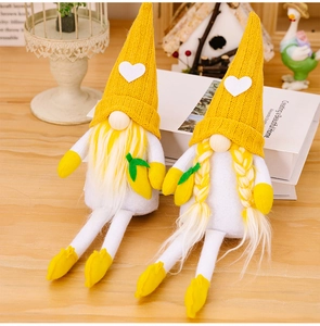 Detail of yellow knitted summer gnomes featuring a lemon accent and cozy home decor props