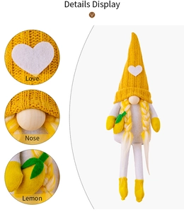 Detailed view of yellow knit lemon gnome doll featuring wooden nose and heart patch