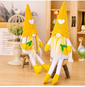 Detail of yellow knitted lemon gnomes with long legs and heart patterns in a cozy setting