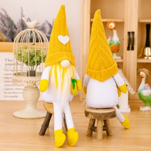 Pair of yellow summer gnomes with knit hats and heart detail for home decoration