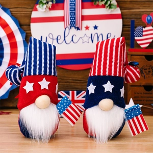Detail of knitted Independence Day gnomes with American flags and star-patterned hats