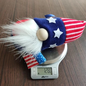 Patriotic gnome decoration showing weight of 128.0g on a digital scale tool
