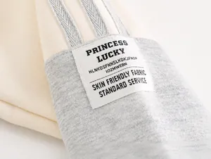 Detail of color-block kid's sweatshirt sleeve with branded patch and soft knit texture