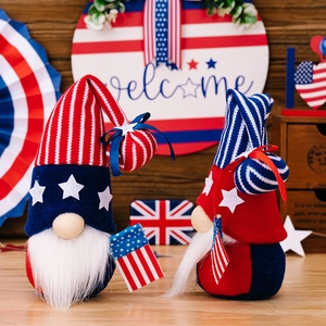 Two patriotic gnome dolls with American flag stars and stripes on a wooden background