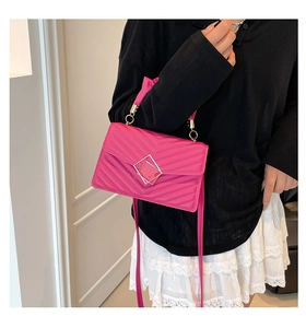 Bright pink quilted handbag with gold square buckle and V-shaped stitching detail