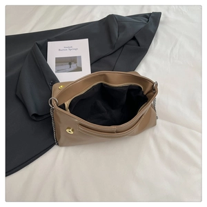Internal view of khaki envelope bag showing the magnetic closure and zipper compartment