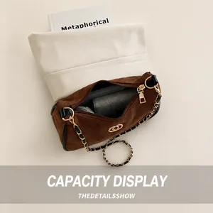 Top view of brown suede quilted chain bag showing interior storage for phone and power bank