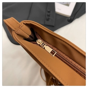 Detail of premium caramel leather tote with golden zipper and precision stitching work