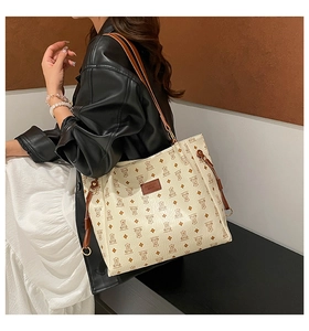 Detail of crossbody bag with cute bear pattern print and fashion bags leather patch