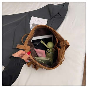 Spacious brown faux leather tote bag interior showing capacity for iPad and daily essentials