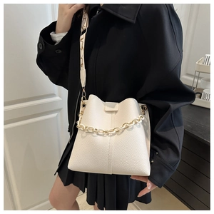 White lychee leather bucket bag with acrylic chain and geometric pattern wide strap