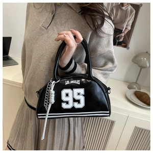 Detail of black crescent handbag with Los Angeles 95 print and silver chain tassel