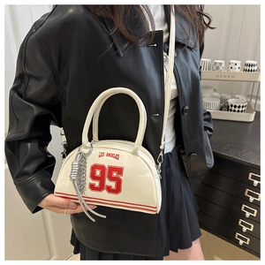 Detail of off-white crescent underarm bag featuring red Los Angeles text and silver chain