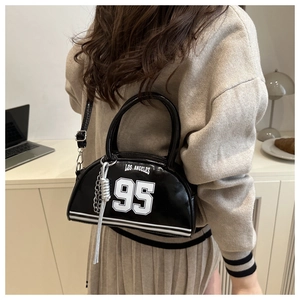 Detail of black sporty crossbody bag with Los Angeles 95 print and silver chain charm