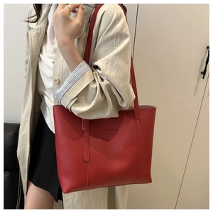 Dettaglio della borsa tote in pelle PU rossa con logo stampato e trama fine