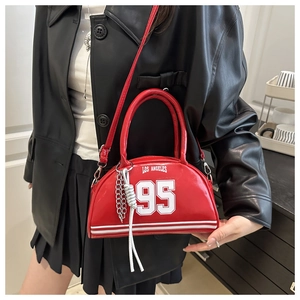 Detail of red crescent shoulder bag with Los Angeles print and silver chain accessory