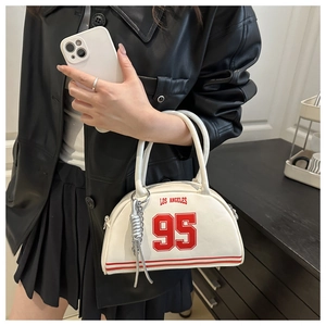 Detail of white Los Angeles bowling bag with red stripes and a silver knot charm