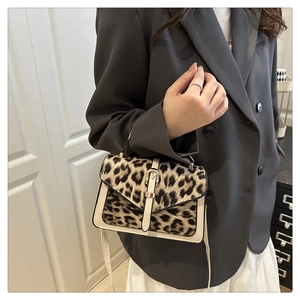 Leopard print crossbody bag styled with high-end grey blazer and pleated skirt