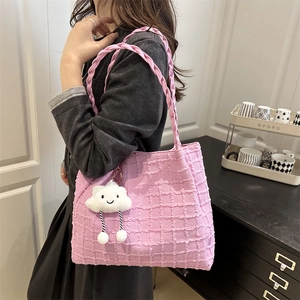 Pink waffle texture tote bag with woven handles and white plush cloud pendant