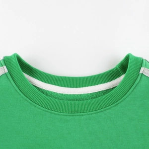 Kids green crewneck sweatshirt with ribbed collar and gray stitching detail flat lay