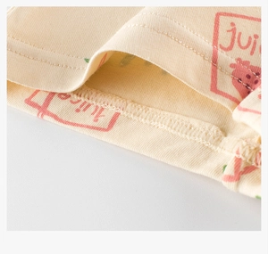 Detailed close-up of strawberry print and overlock stitching on cotton girls' underwear