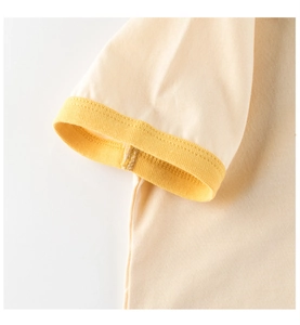 Close-up of high-quality cotton knit fabric and ribbed cuff on a cream kids' t-shirt