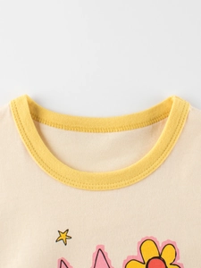 Children's cream cotton T-shirt featuring a yellow ribbed neckline and cartoon prints