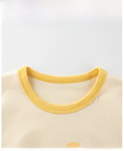 Detail of a yellow cotton toddler T-shirt showing smooth ribbed crewneck stitching