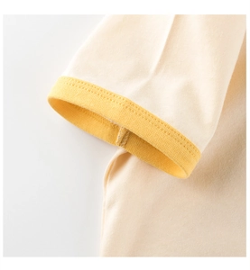 Detailed close-up of yellow ribbed cuffs and precise stitching on cotton toddler t-shirt