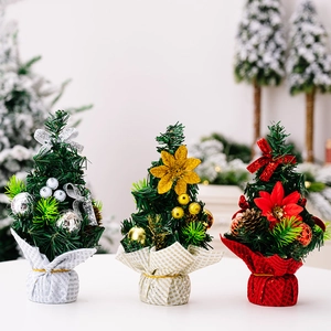 Mini Christmas trees set with glitter flowers, ribbons, and pine cones on cloth bases