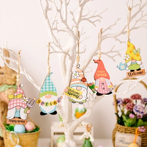 Easter wooden gnome ornaments with spring floral patterns hanging on a decorative tree