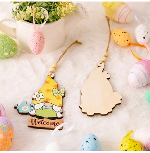 Close-up of Easter wooden gnome ornaments with Welcome text on a white plush background