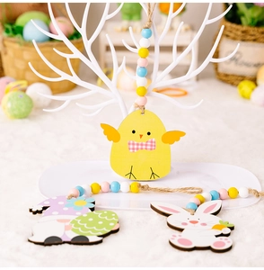 Detailed view of Easter wood ornaments with colorful beads on a decorative white stand