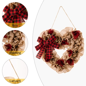 Detail of red checkered bow and burlap heart wreath with rustic fabric textures