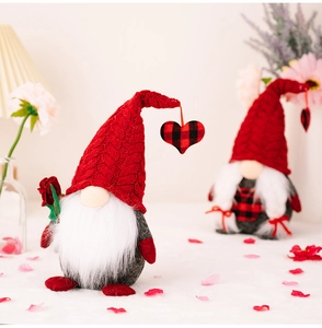 Detailed view of red knitted Valentine's Gnomes with plush beard and rose decoration