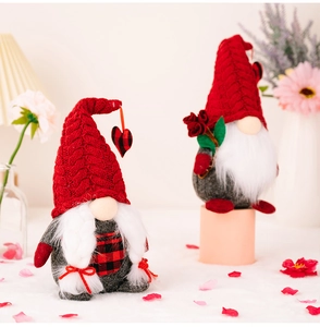 Close-up of Valentine gnome plush couple with red knit hats and heart details