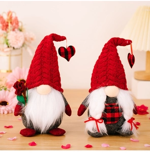 Close-up of Valentine Gnomes with red knit hats and roses on a wooden table