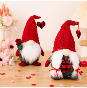 Close-up of Valentine's Day gnome plush set with knit hats and heart details on wood table