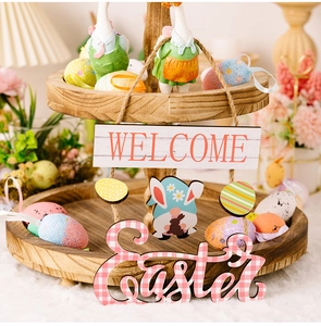Close-up of Easter tiered wooden tray with rabbit, colorful eggs and welcome sign