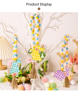 Detail of Easter wooden bead garland with rabbit pendants and tassels on a decorative tree