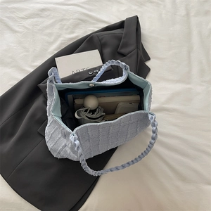 Interior view of light blue tote bag showing spacious capacity for tablets and umbrellas
