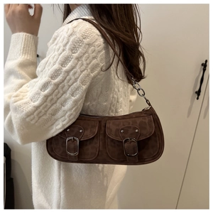 Detail of dark brown leopard print baguette bag with front pockets and metal buckles