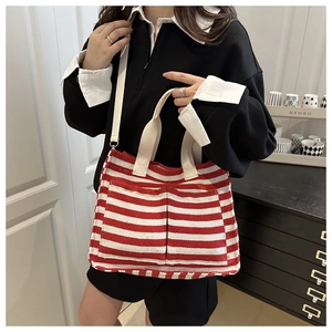 Detail of canvas tote with red and white horizontal stripes and dual front pockets