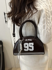 Brown patent leather crescent underarm bag with Los Angeles 95 print and silver chain detail