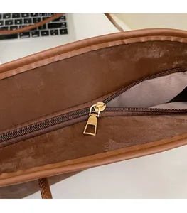 Detail of premium gold zipper and brown leather lining on a large tote bag